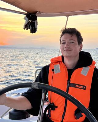Paul Heisig steering a boat
