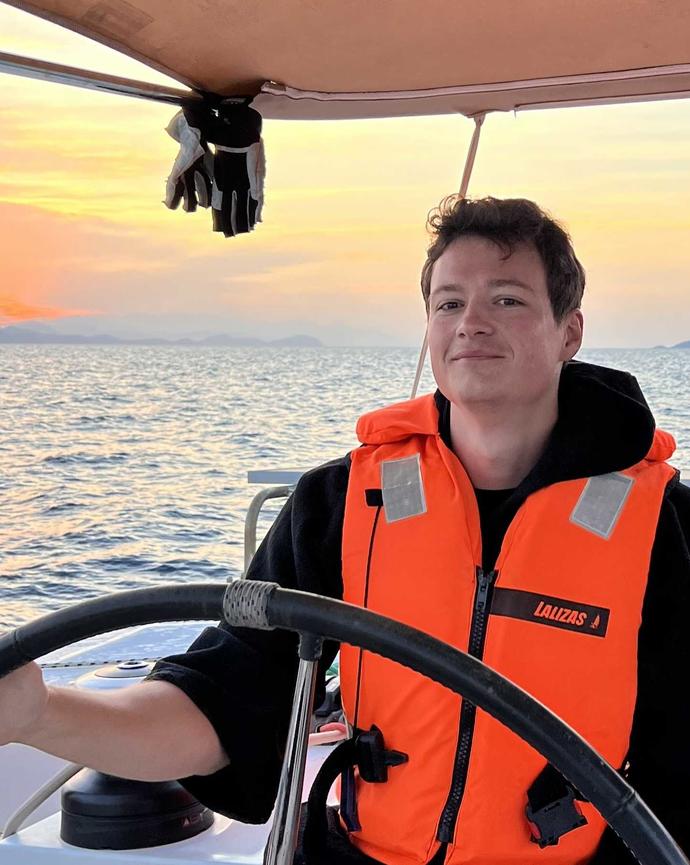Paul Heisig steering a boat